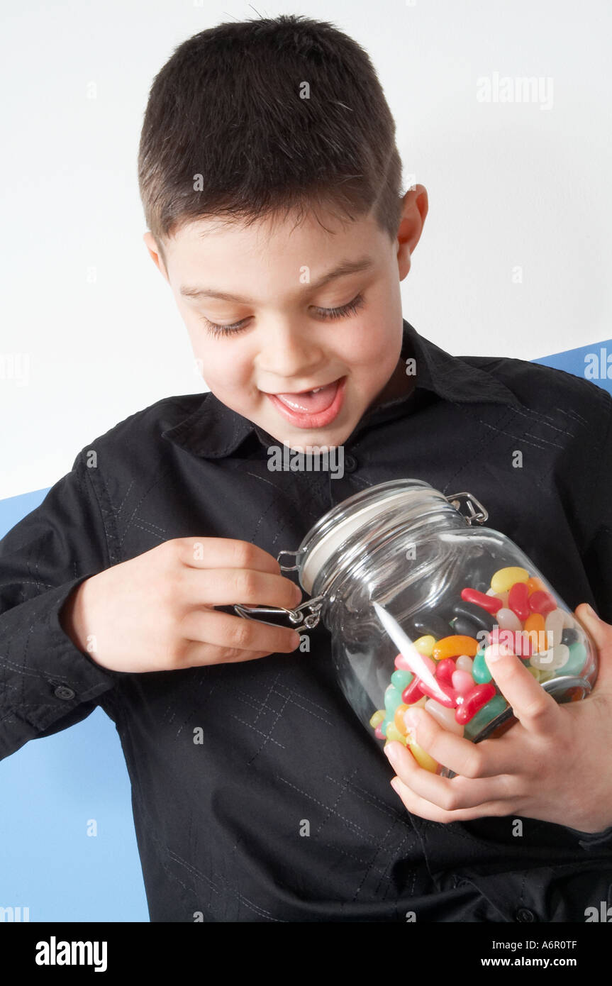 Young, boy, child, kid, eating, jelly beans, sweets, sweeties, candy, food, colourings, colorings, colour, color, artificial, fl Stock Photo