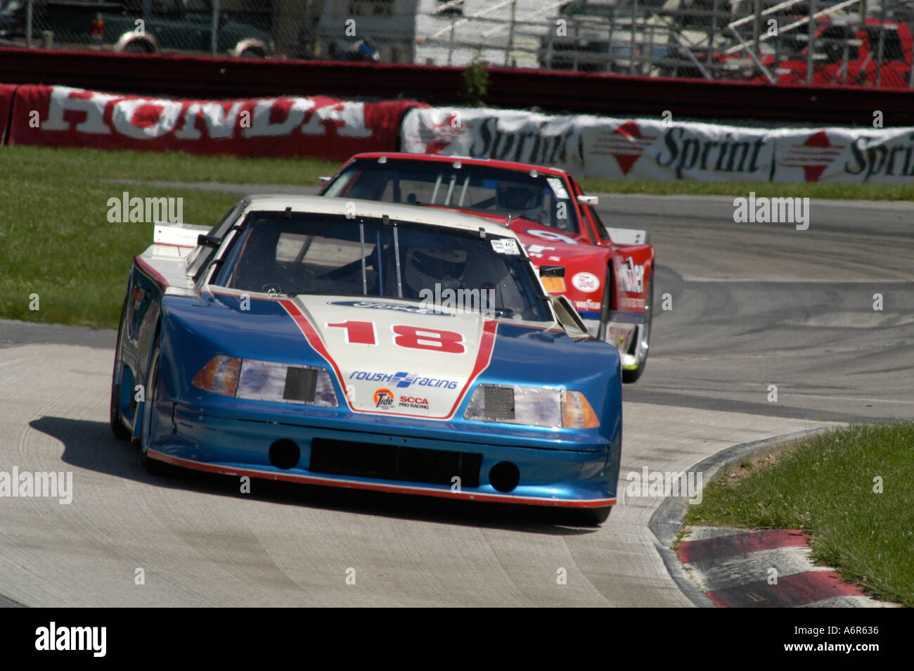 Peter Klutt in his 1990 Mustang Trans Am leads Richard Howe in his 1989
