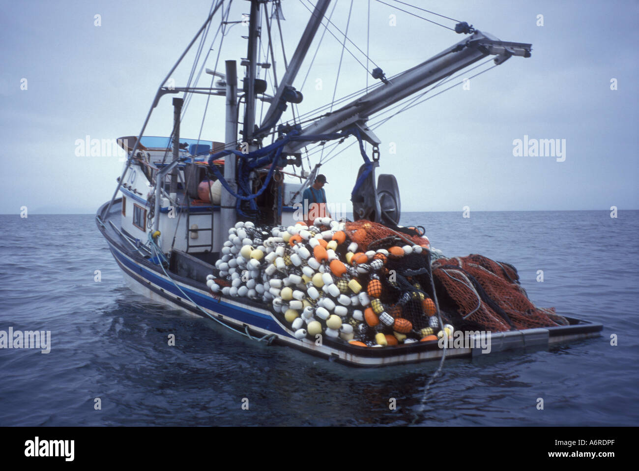 Salmon seiner fishing vessel loaded heavy with fish and nets in waters off Kodiak Island Pacific ocean Alaska Stock Photo