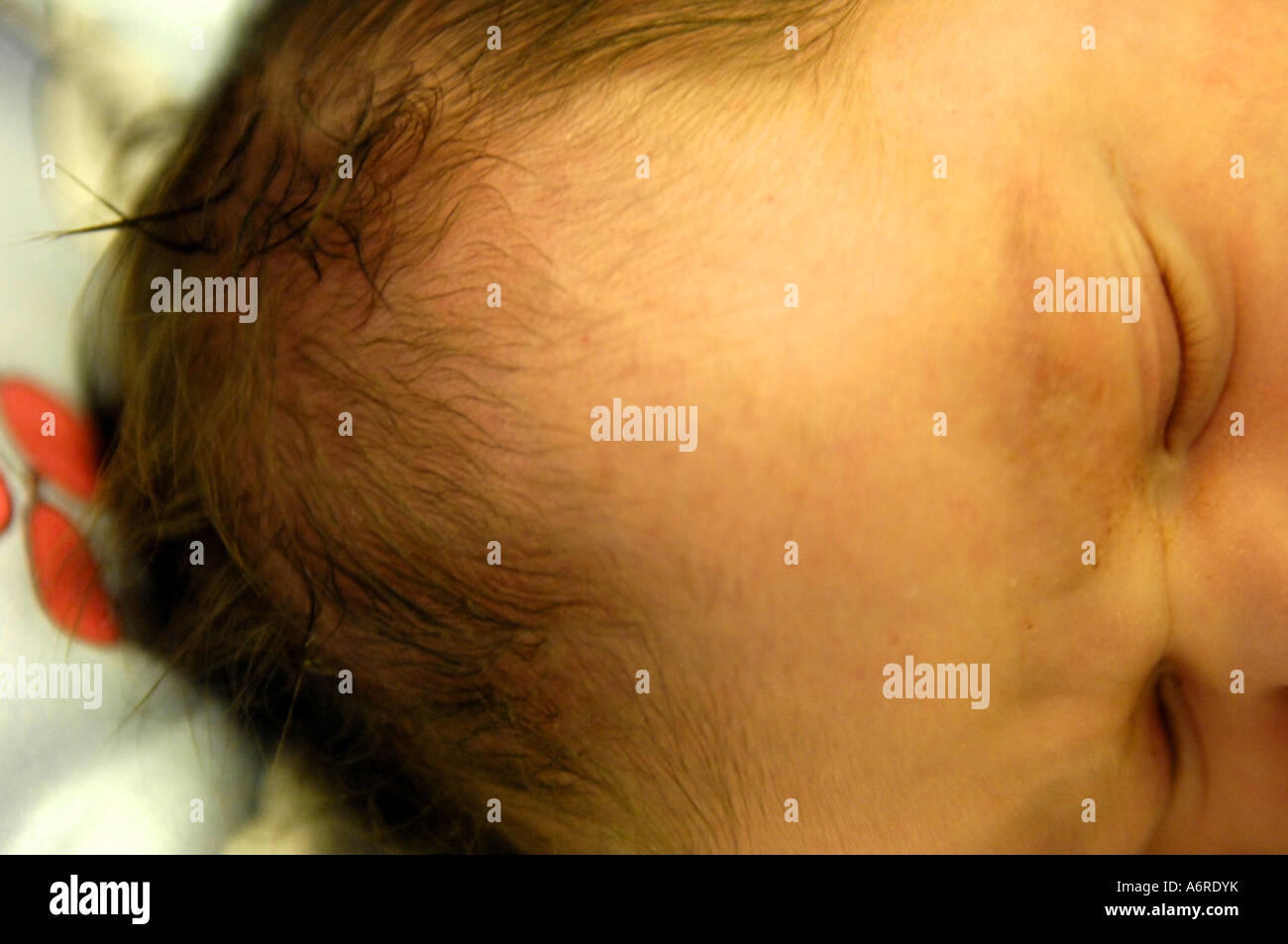 newborn baby head black hair caucasian dark face sleep eyes closed shut