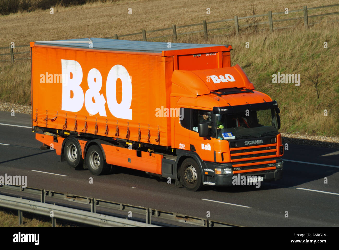 B&Q DIY retail business logo on delivery lorry truck soft side folding easy access curtain raised rear axle for tyre wear economy driving UK motorway Stock Photo