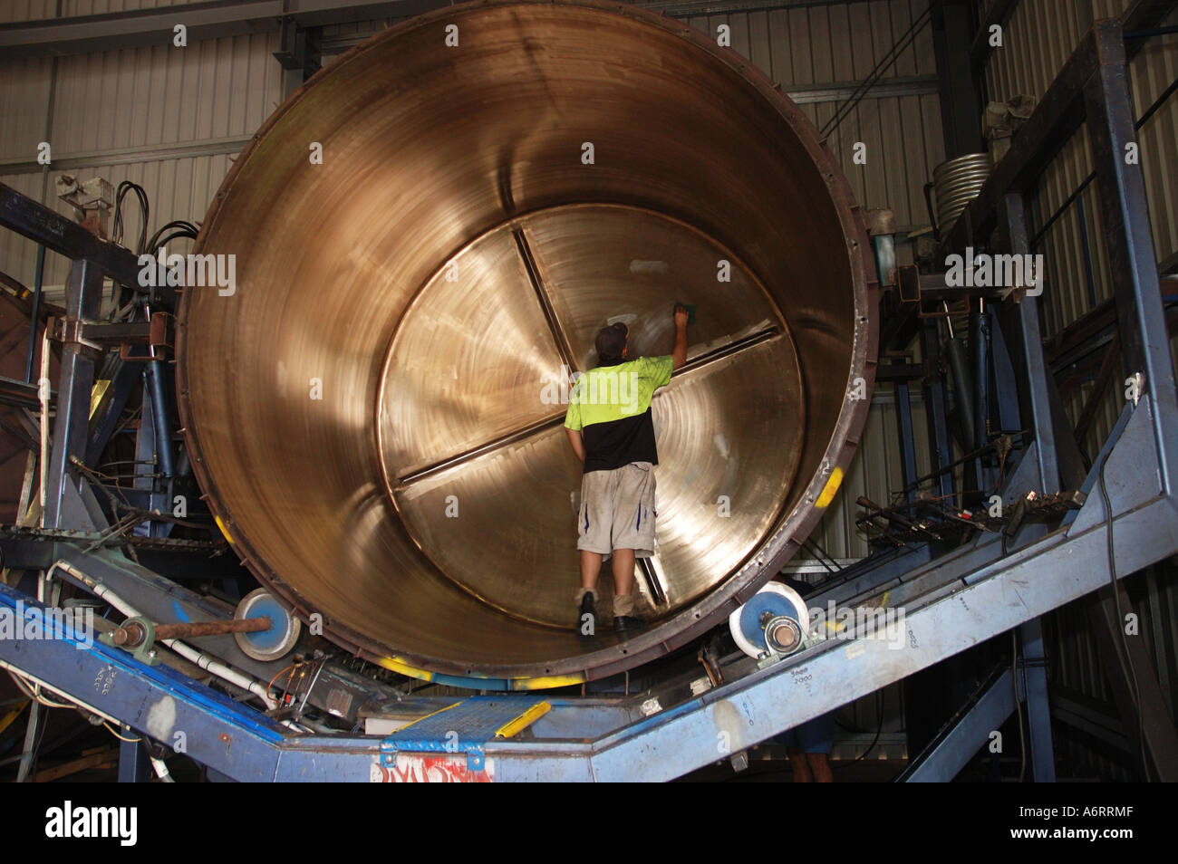 worker cleans mould for rainwater tank Stock Photo