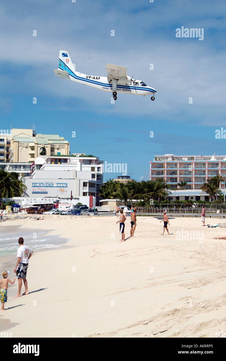 Air planes land at runway which ends at the Sun Beach on the Caribbean Island of St Maarten Martin in the West Indies Stock Photo