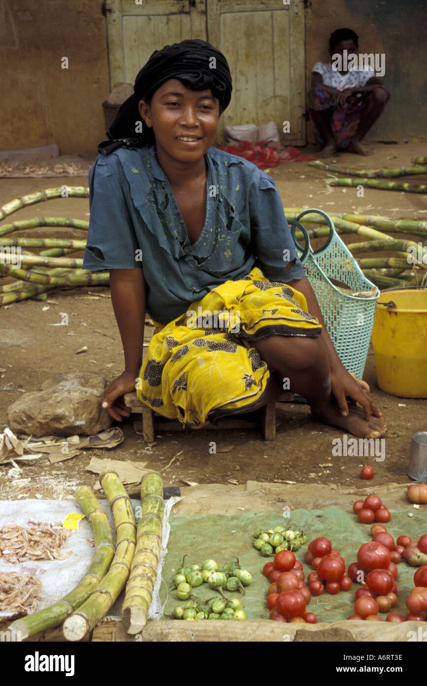 Africa, Madagascar. Diego Suarez, local market and woman selling tomatoes, broccoli and sugar cane. Stock Photo