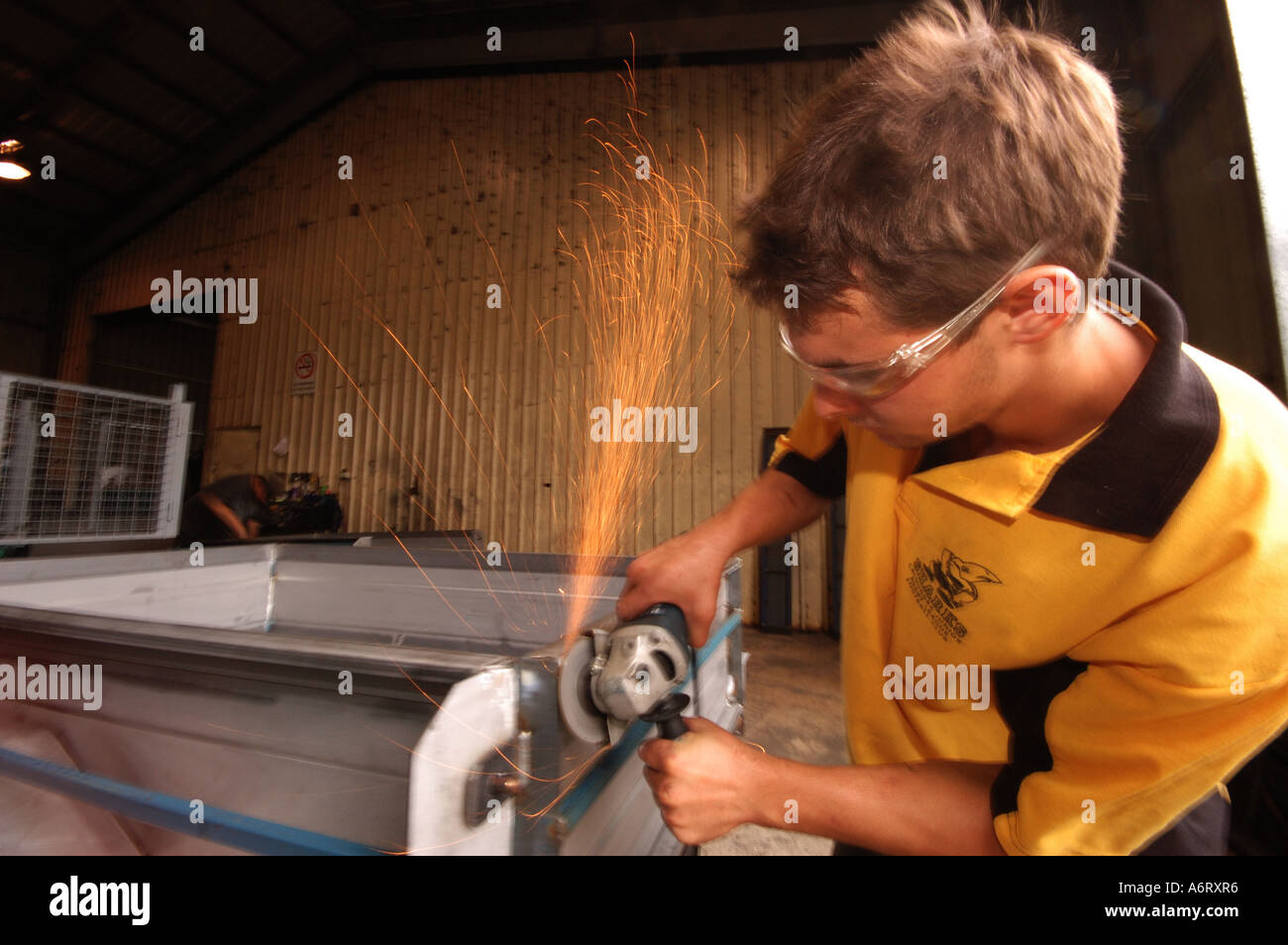 young worker with angle grinder Stock Photo
