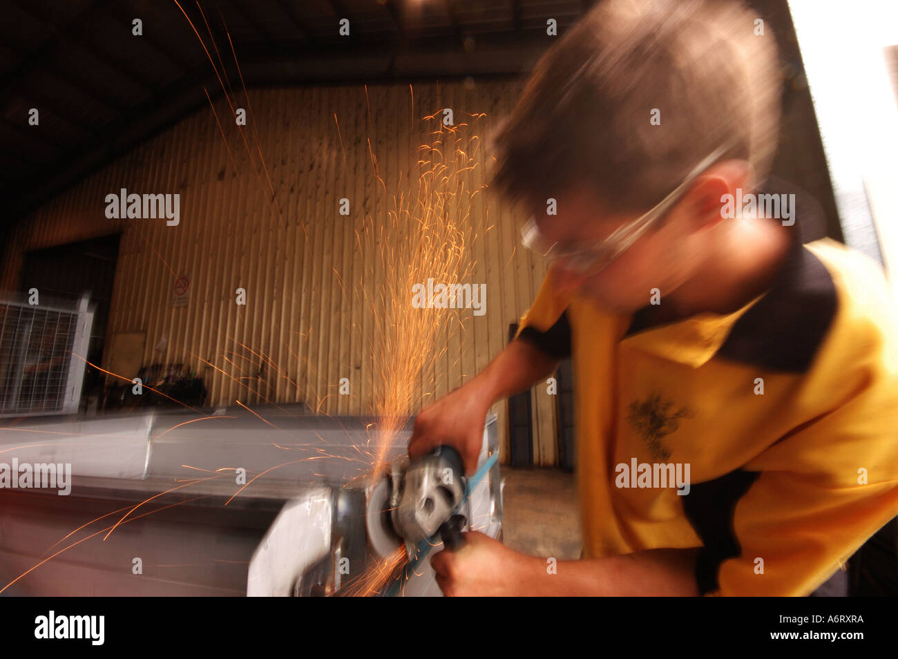 young worker with angle grinder Stock Photo