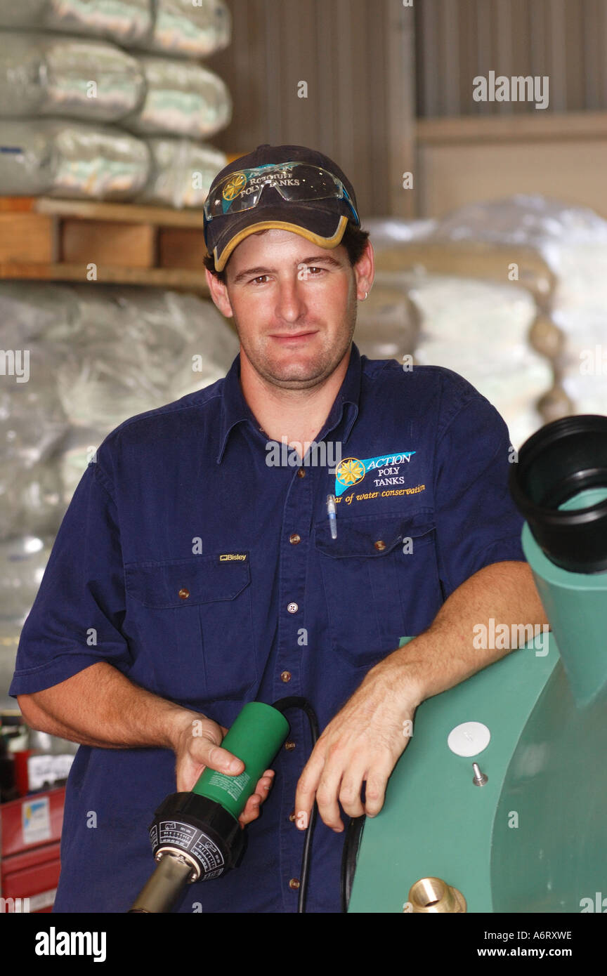 Factory worker manufacturing plastic rainwater tanks Noosa Queensland