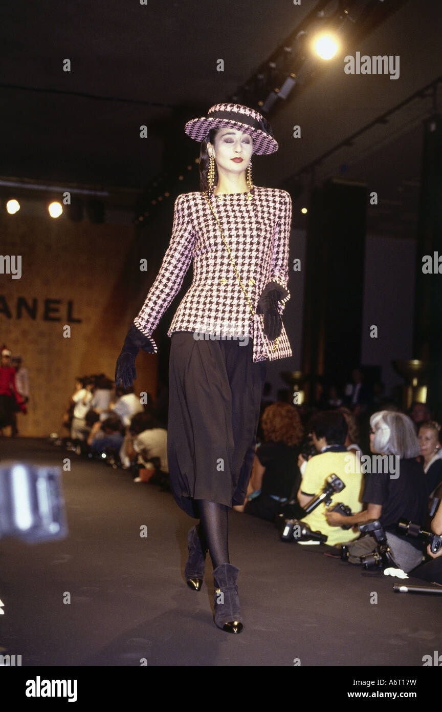 Model is wearing Chanel's complete ensemble, skirt, blouse, jacket