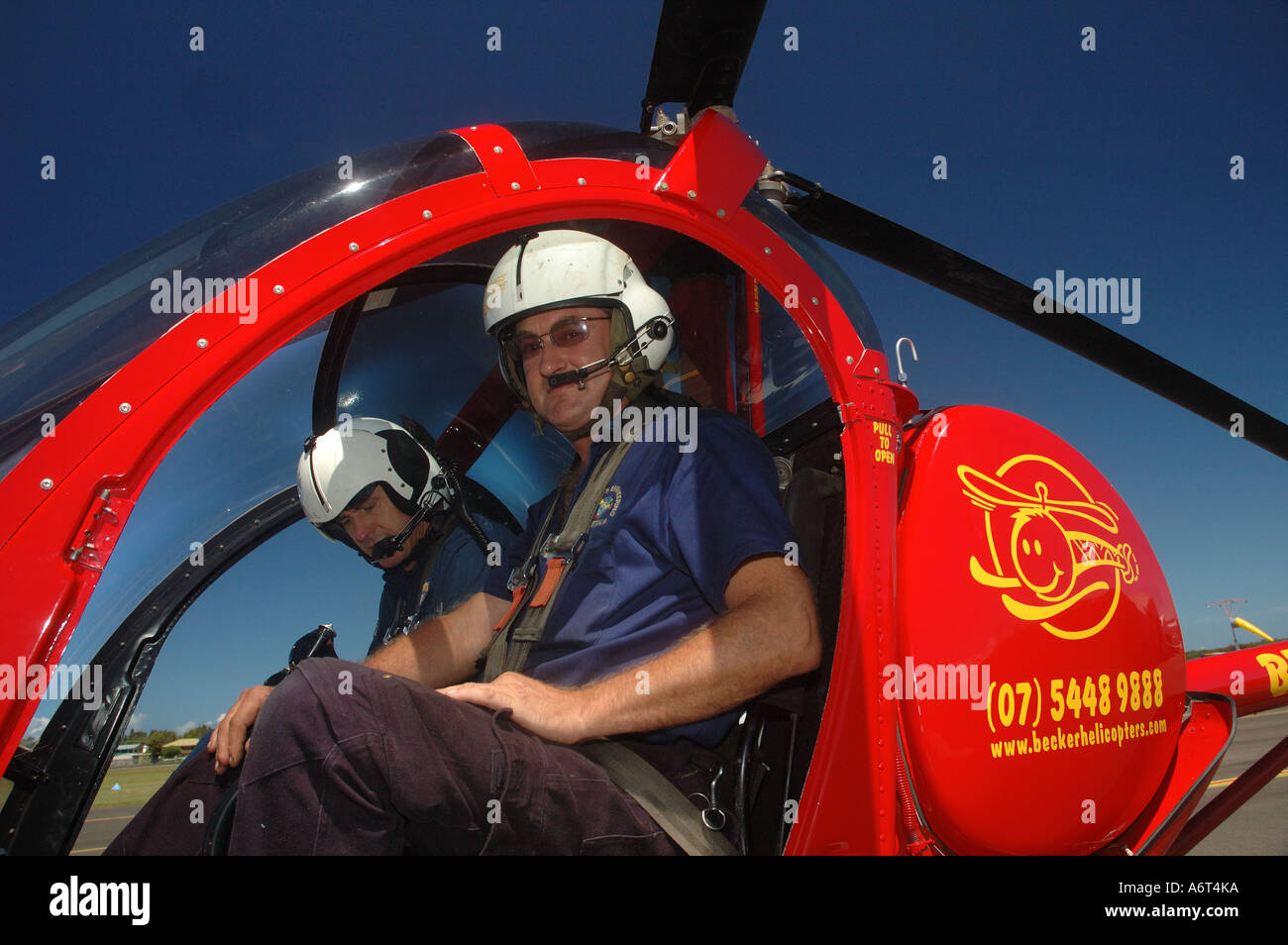 Pilot and Co copilot in small cattle muster chopper Queensland Australia Stock Photo