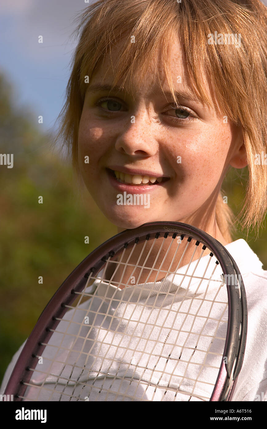 young girl outside holding tennis racket Stock Photo - Alamy
