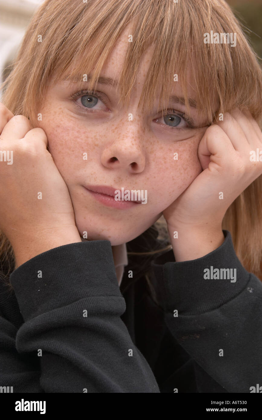 young girl with head in hands daydreaming Stock Photo
