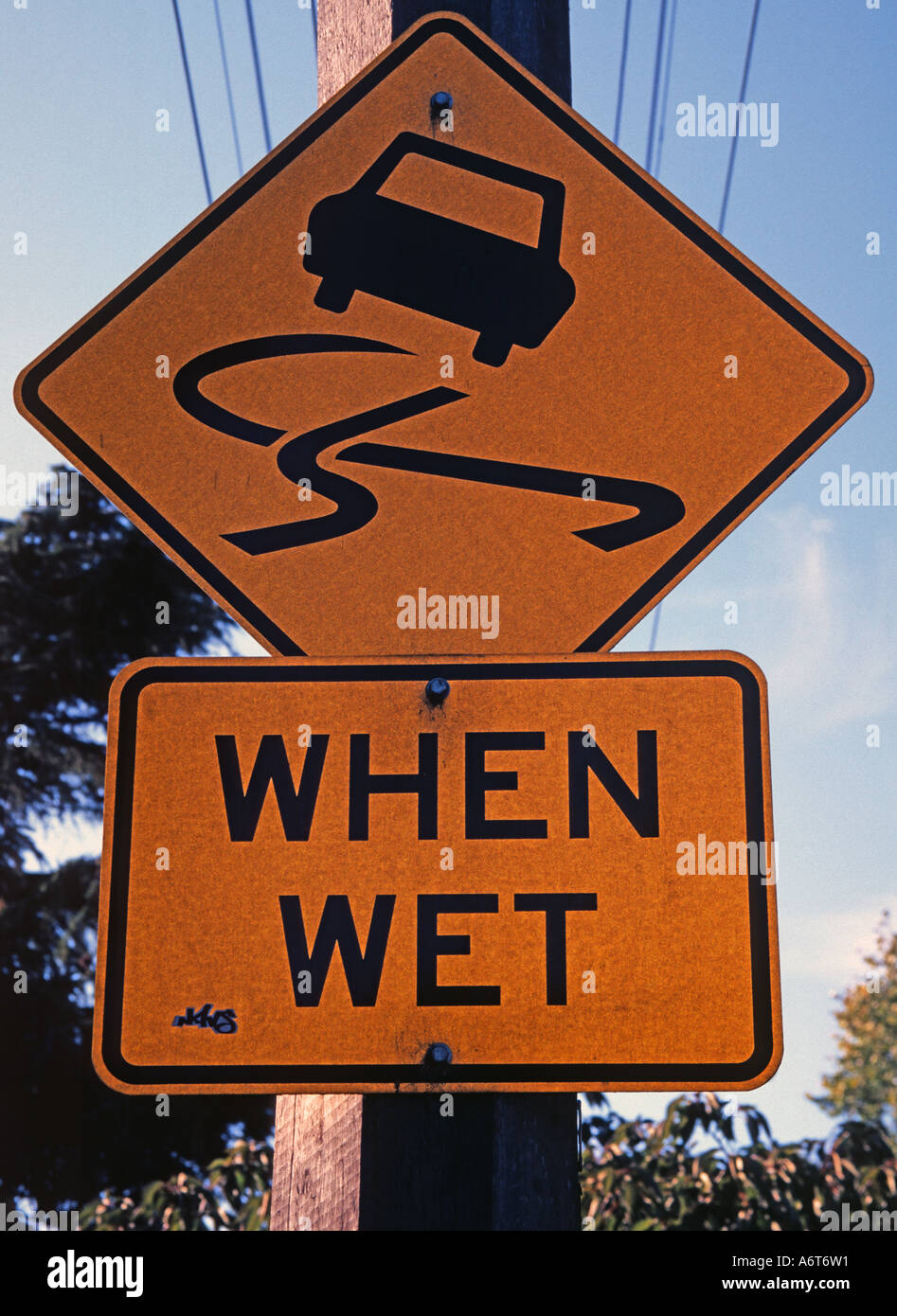 Slippery when wet road sign Stock Photo Alamy