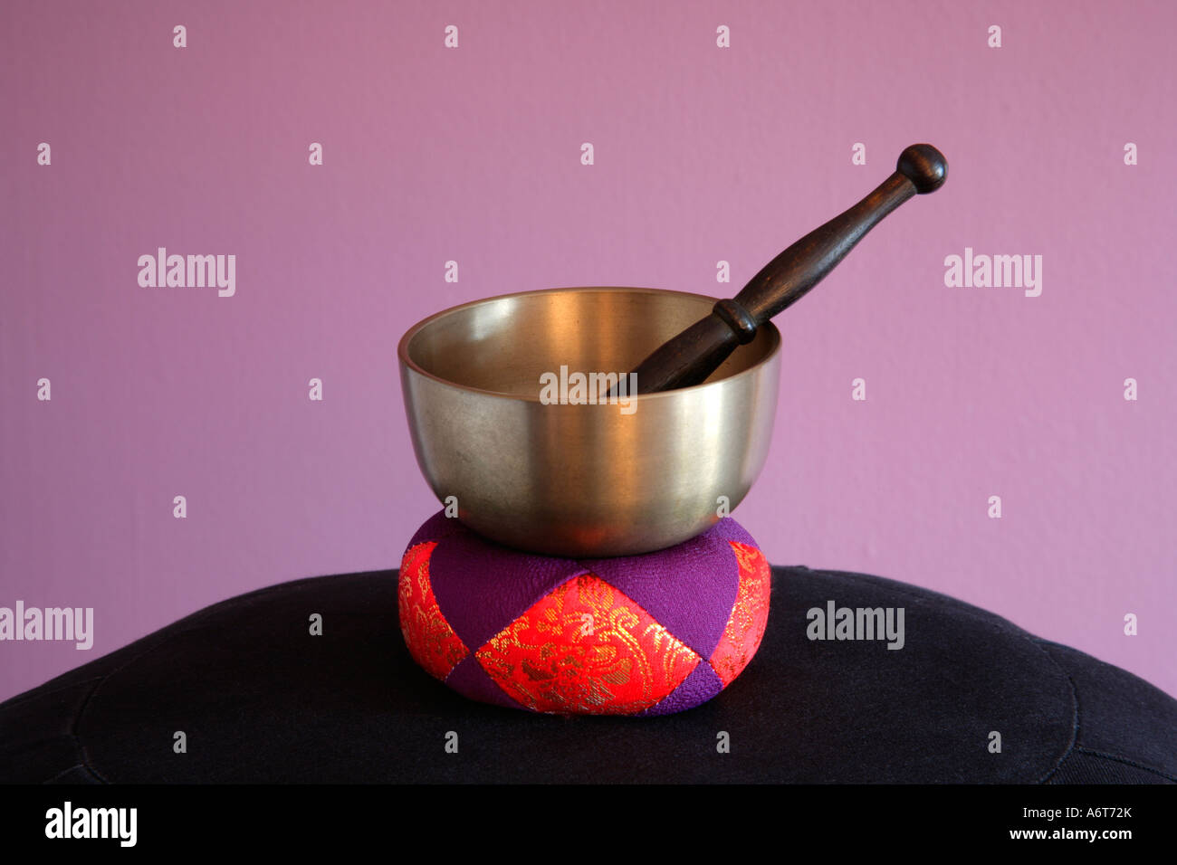 Zen Buddhist Bell Bowl with bell stick on ceremonial cushion Stock Photo -  Alamy