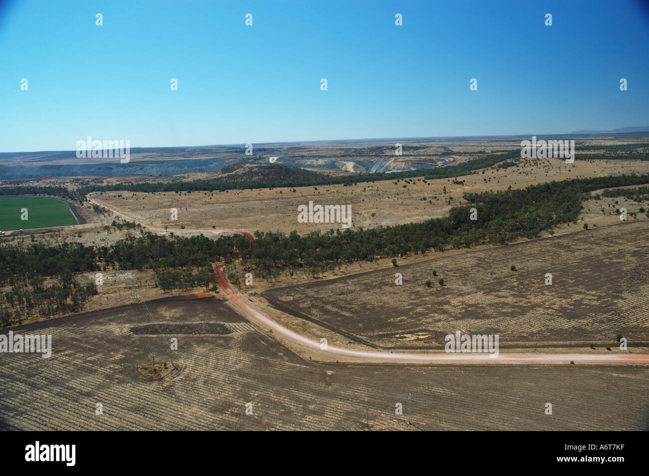 Outback river runs through dry farming land Central Queensland coal basin Australia Stock Photo