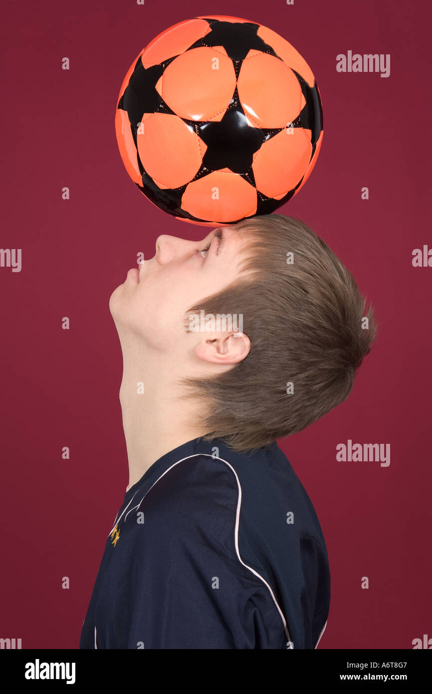 Young Man Balancing Soccer Ball on Head Stock Photo Alamy