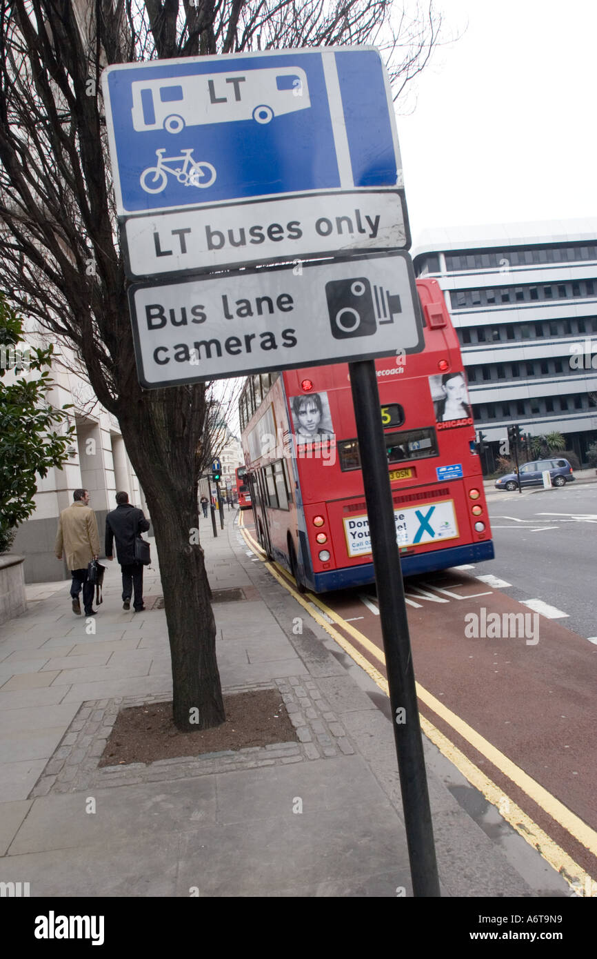 LT Bus only sign and Bus Lane cameras sign with moving bus in the City of London, GB UK Stock Photo