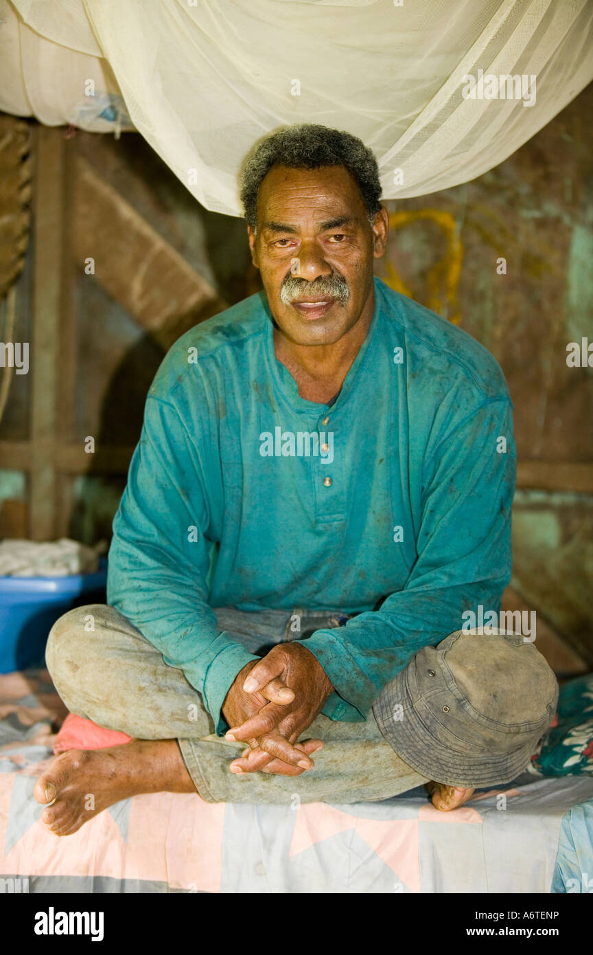 A Fijian man in his hut in Bukaya village, Fiji Stock Photo