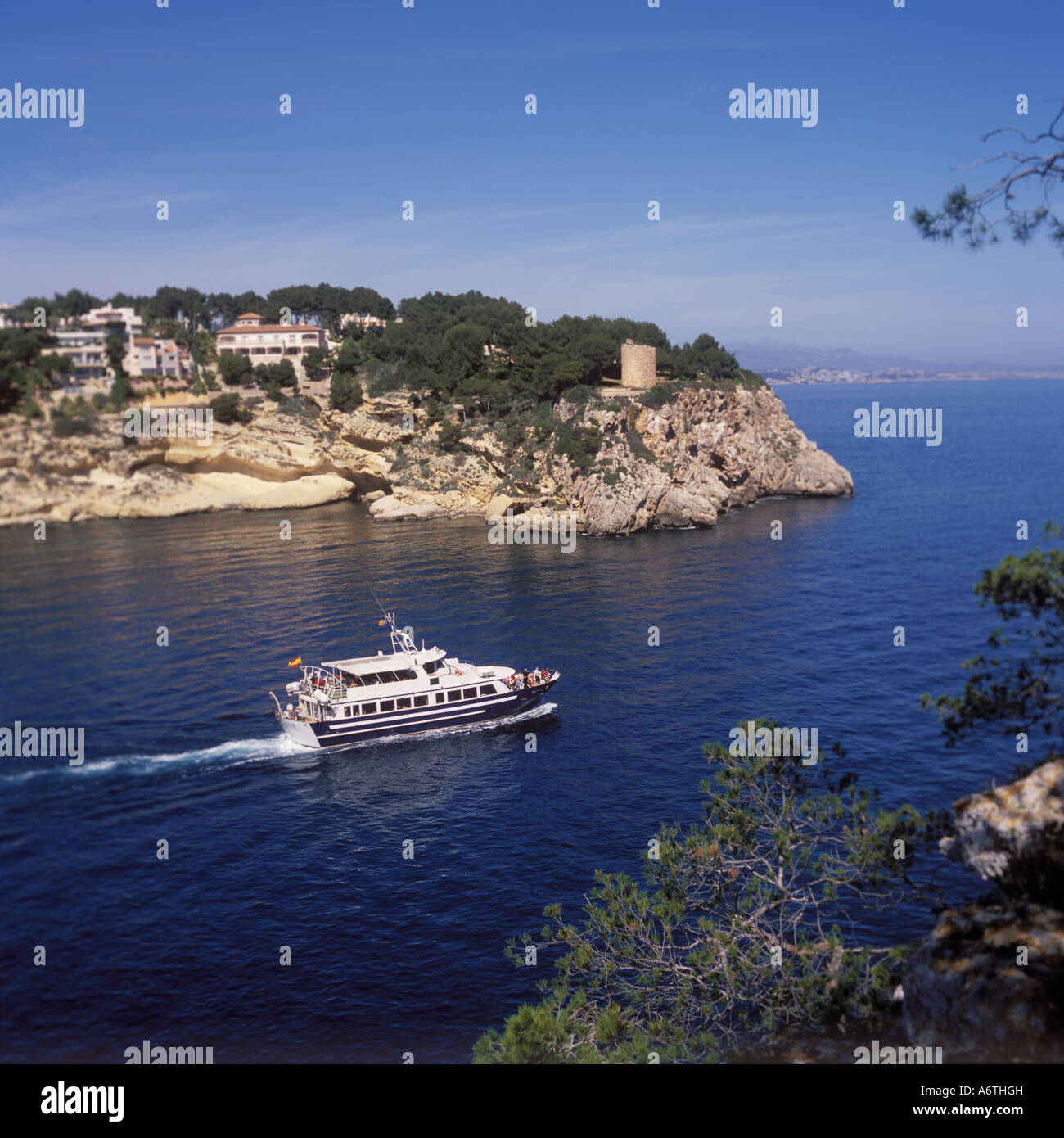 Scene with tourist boat departing the bay / anchorage of Portals Vells, Calvia South West