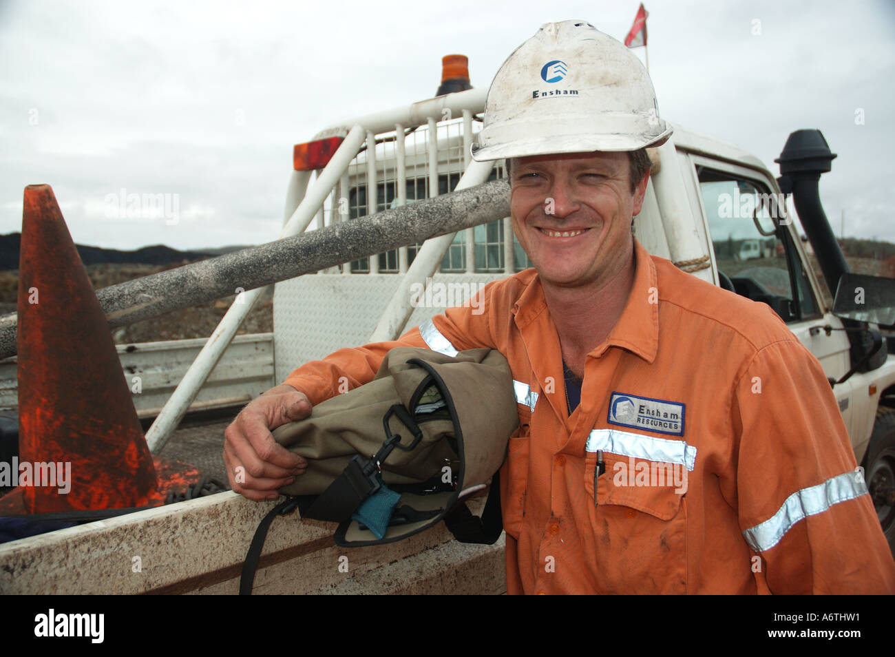 Mine engineer worker leaning on his vehicle Stock Photo