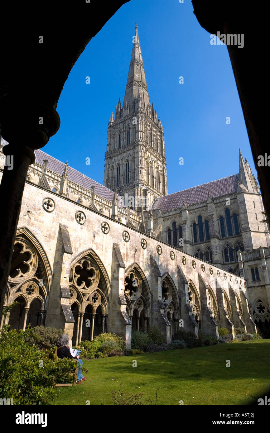 Salisbury Cathedral from inside the Cloisters A person sits on a bench in the calm yet invigorating spring sunshine Stock Photo