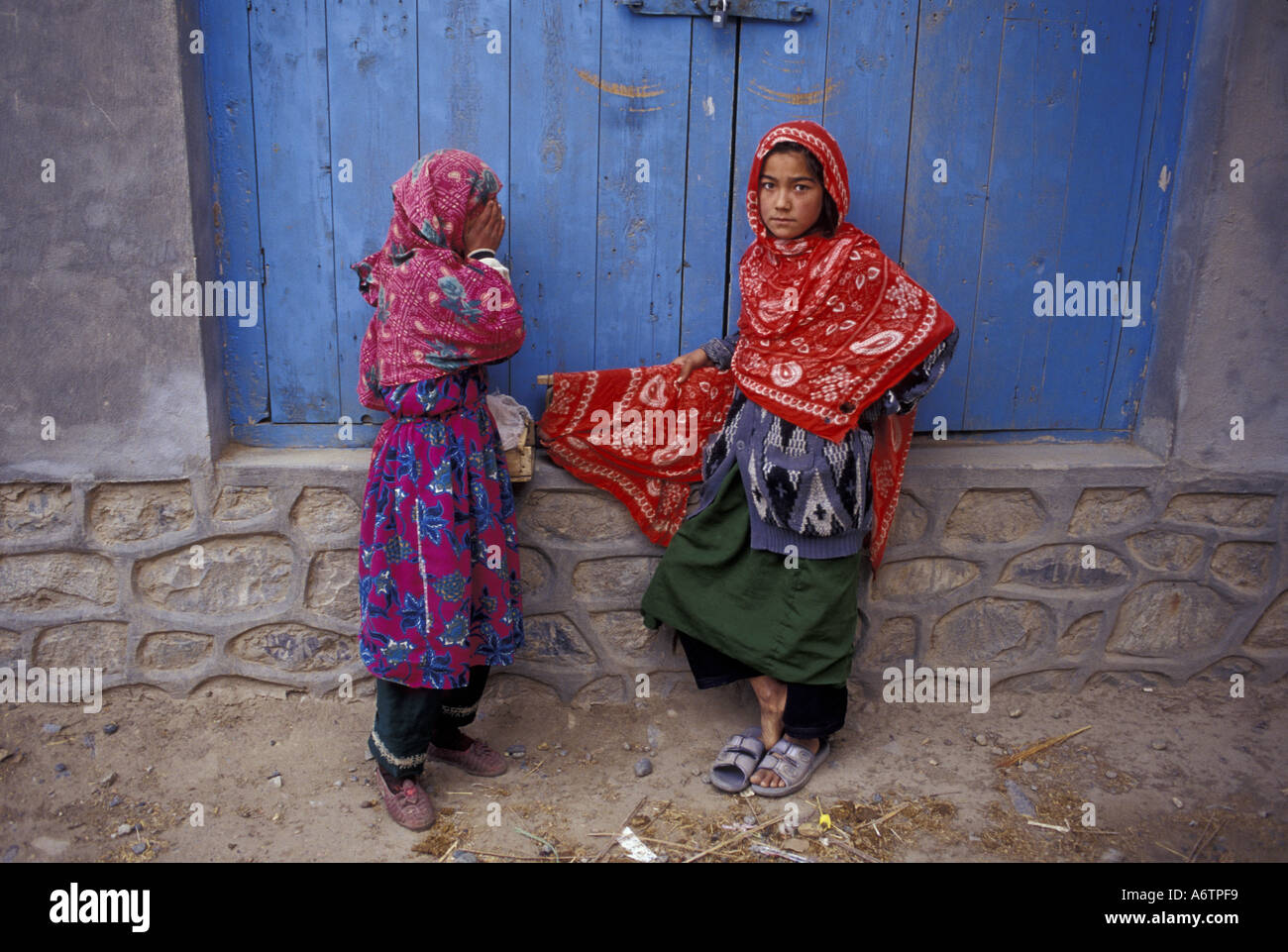Afghanistan, Dash-ti-Qala, near the Tajikistan border, Two young Afghani women with food items to sell in the market Stock Photo