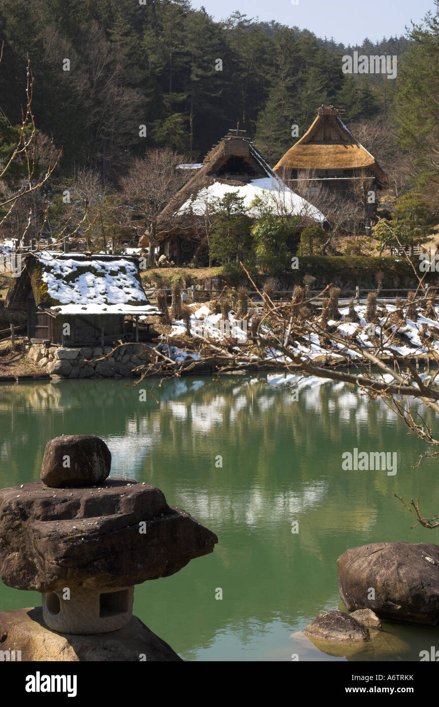 Japan Central Honshu Hida District Takayama Hida No Sato Hida Folk Village view with pond and traditional stone stand in frgd an Stock Photo