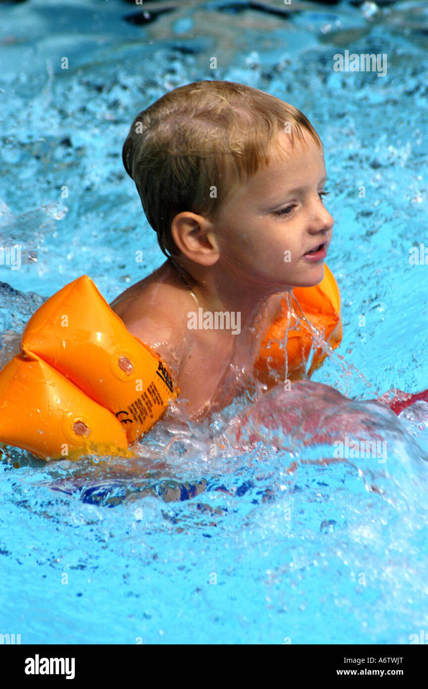Young boy age 3 swimming kicking Stock Photo