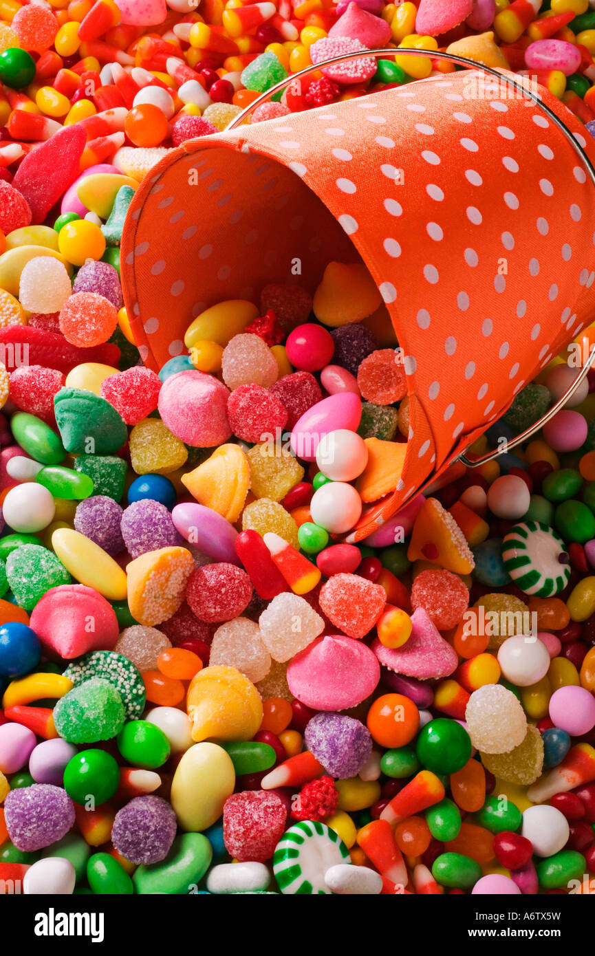 Orange bucket with large amount of candy Stock Photo Alamy