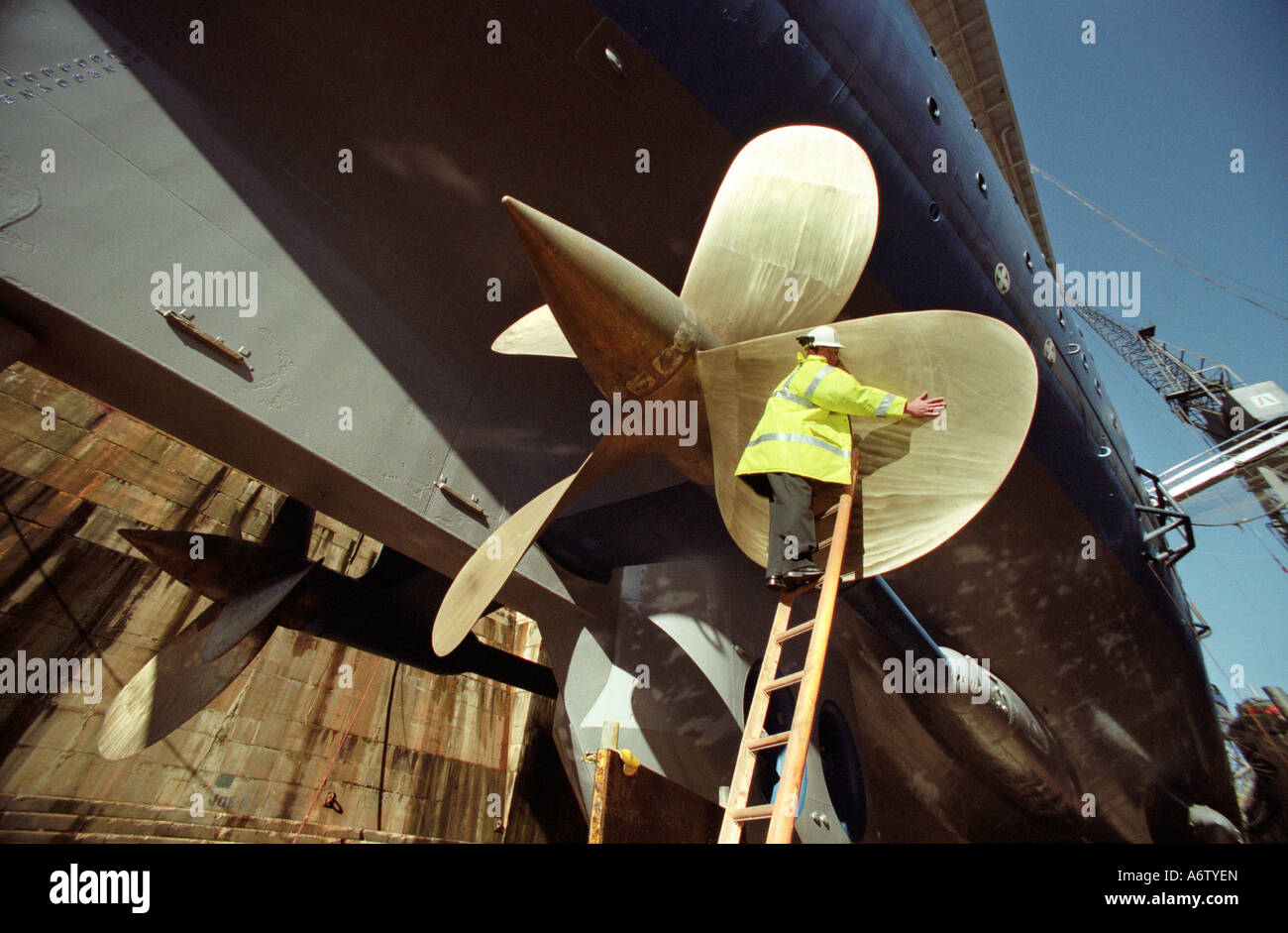 An engineer inspecting the propeller of SS Norway a cruise liner at Southampton Dock Stock Photo