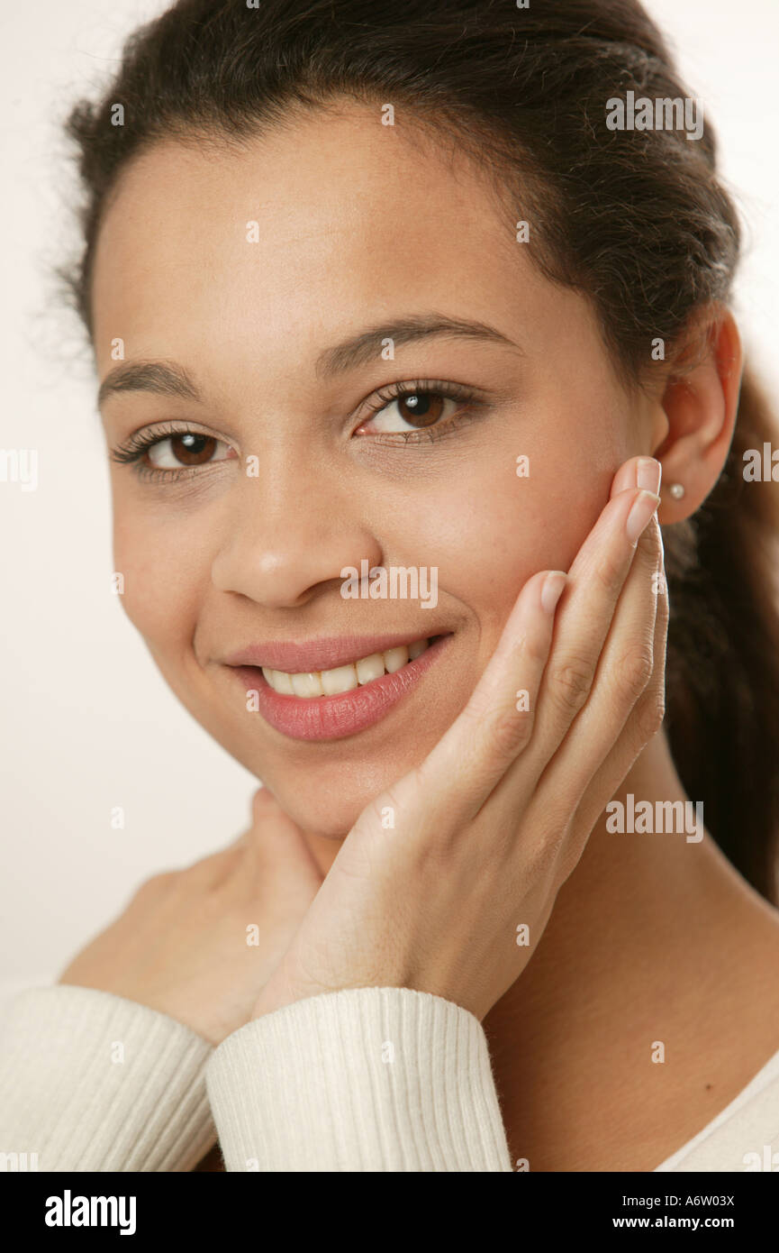 Young girl touching her face with her hands Stock Photo