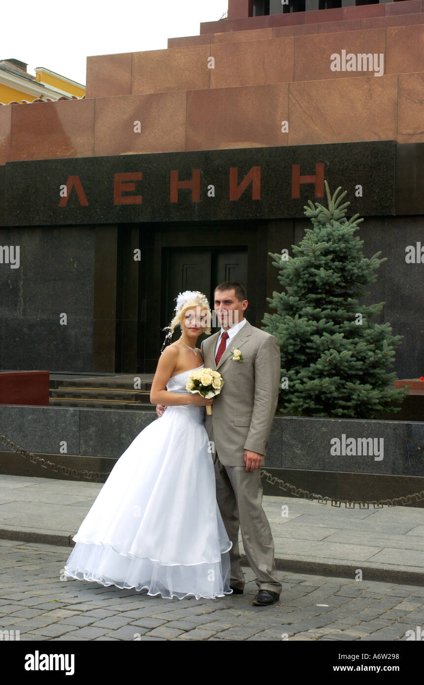 A newly wed couple pose for photographs in front of Lenin s Tomb in Red Square Moscow Russia Stock Photo