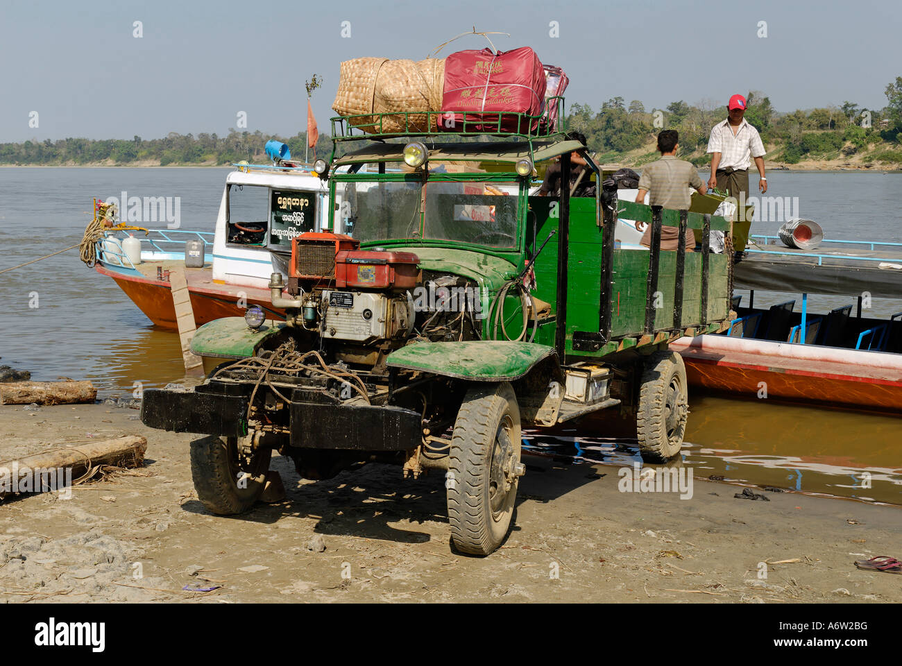 Old vehicles on the banks of the Irrawaddy river, Myanmar Stock Photo