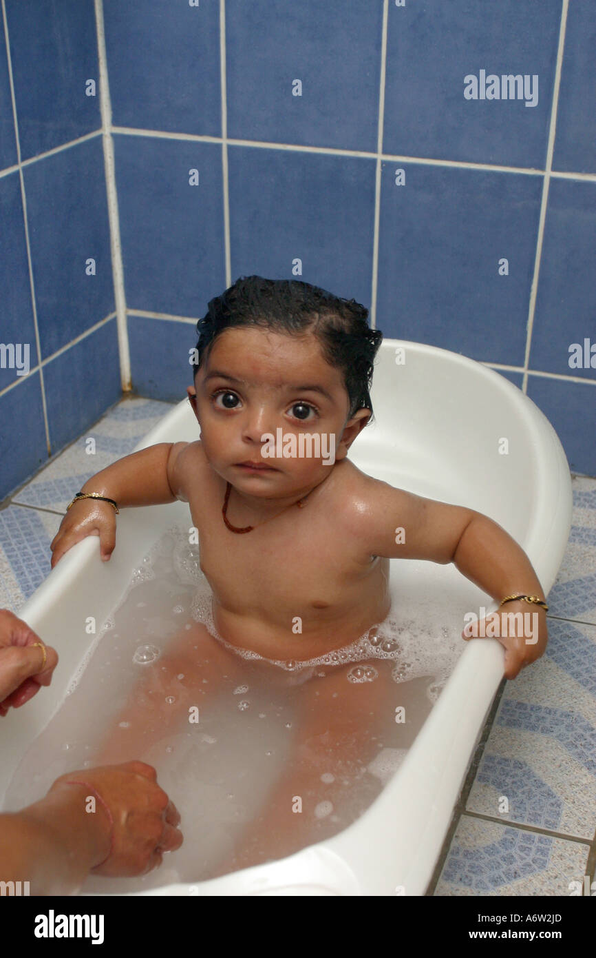 Eighteen Month Baby Being Bathed In Small Tub Stock Photo Alamy