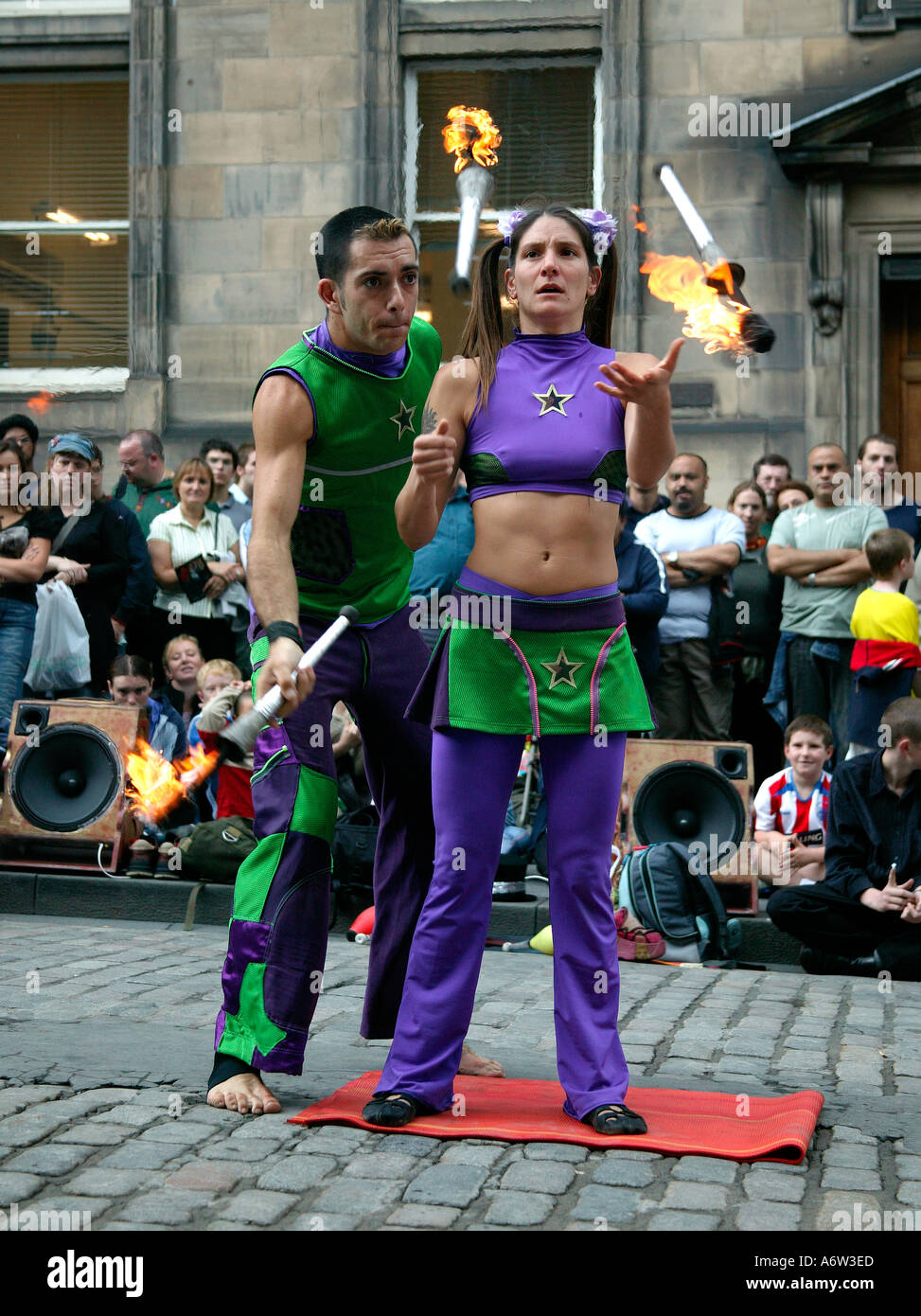 Male and female Street Performers juggling fire torches at the Edinburgh Fringe Festival Scotland UK 2004 Stock Photo