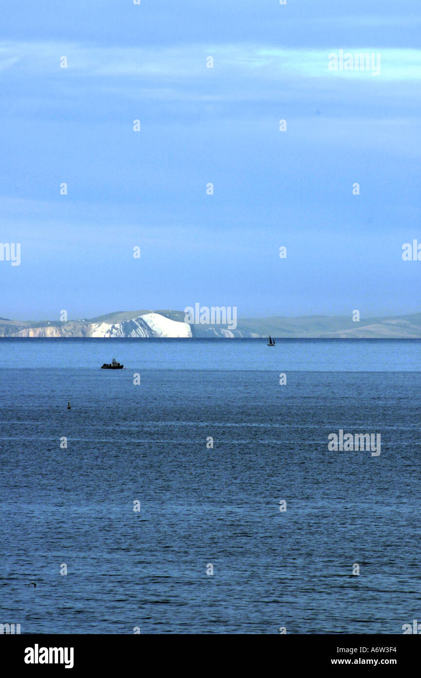Needles and white cliffs on Isle of Wight picked out in evening sun Stock Photo