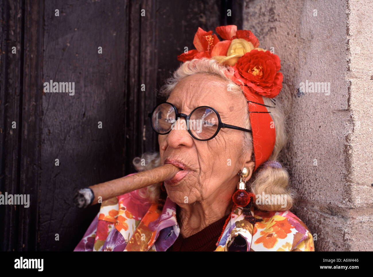 Cuba Havana woman smoking a cigar in a doorway in the old town Stock Photo