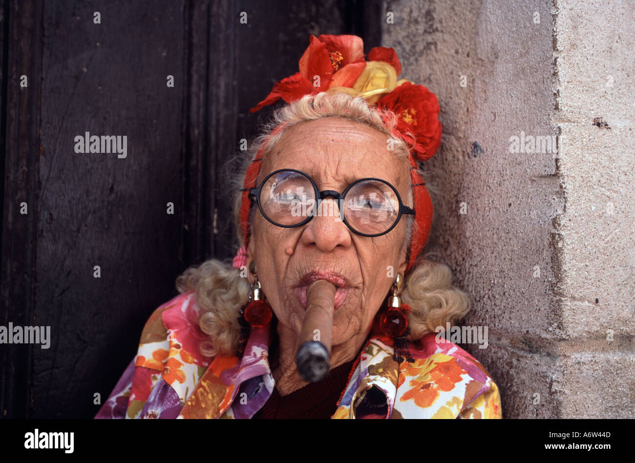 Cuba Havana woman smoking a cigar in a doorway in the old town Stock Photo