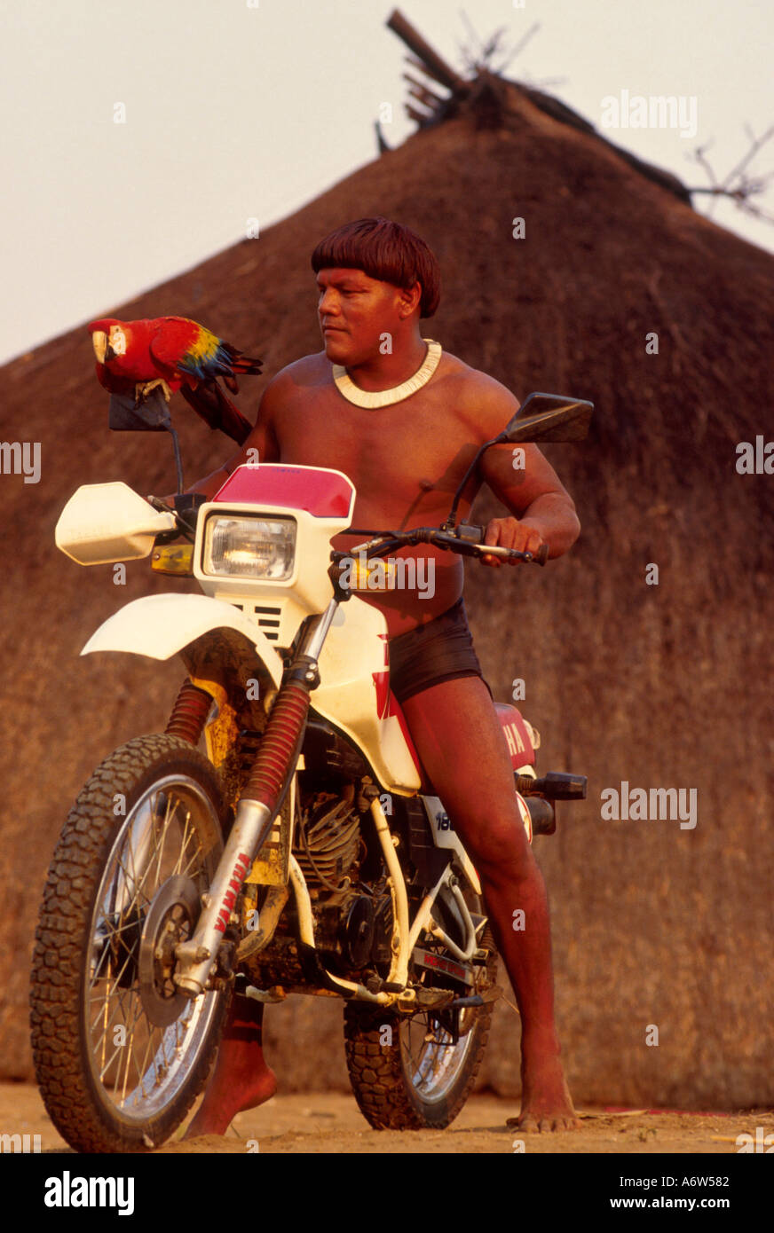 Acculturated brazilian indian Xingu Amazon rainforest Brazil Yaulapiti Indigenous People Native rides a motor cycle motor Stock Photo