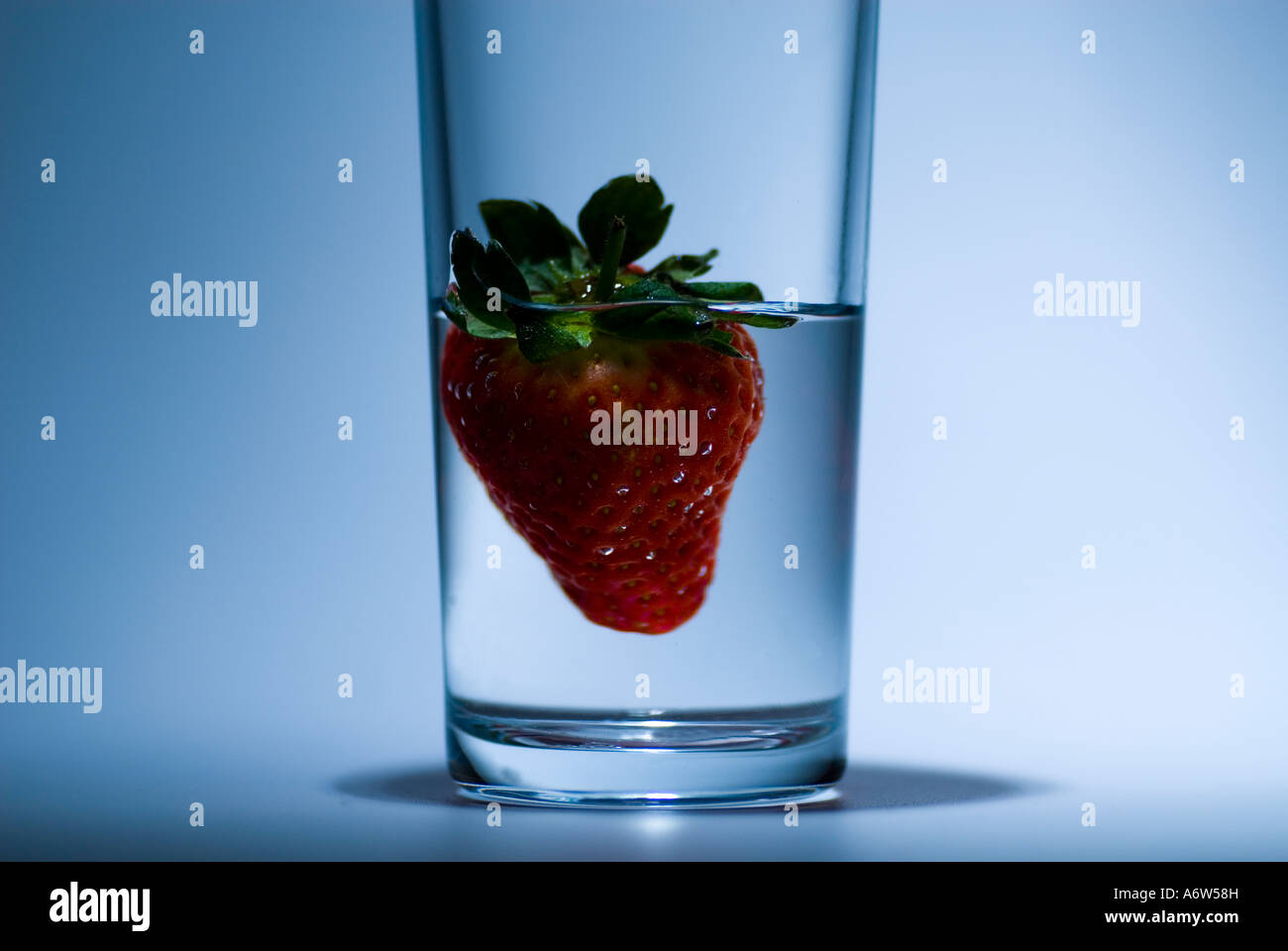 Conceptual image of a strawberry in a glass Stock Photo - Alamy