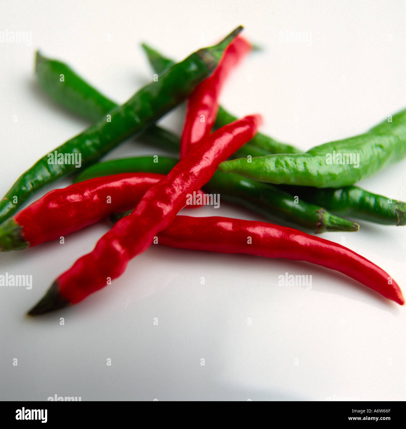 Red and green Thai chillies on a white background Stock Photo - Alamy