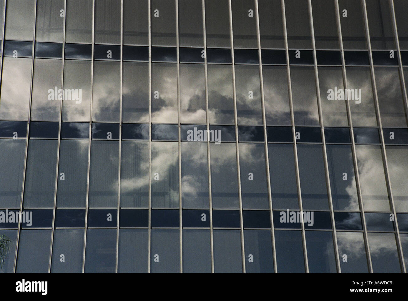 Blue sky and clouds reflected on office building Stock Photo - Alamy
