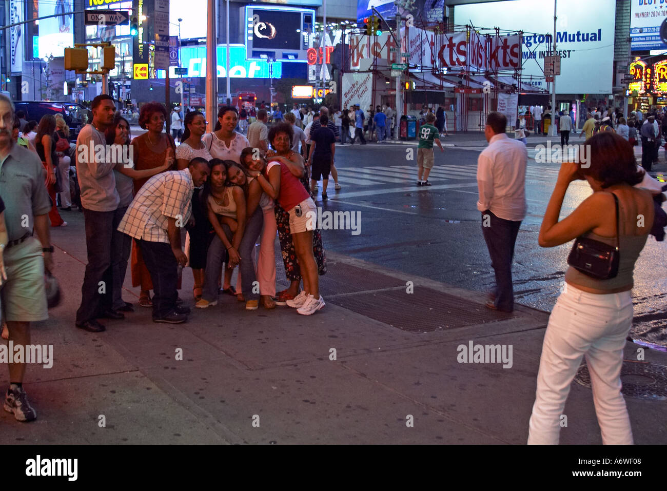 A group of tourists pose for a photo in Times Square New York City ...