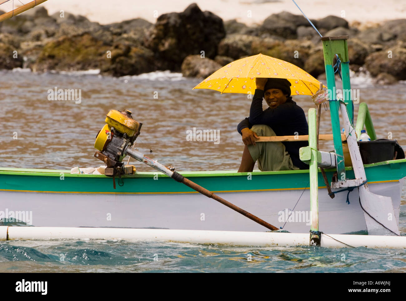 fisherman holding umbrella on boat Stock Photo - Alamy