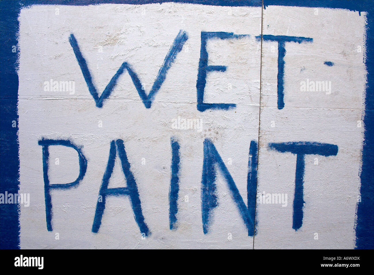 a-hand-painted-wet-paint-sign-written-in-blue-paint-on-a-painted-white-square-stock-photo-alamy
