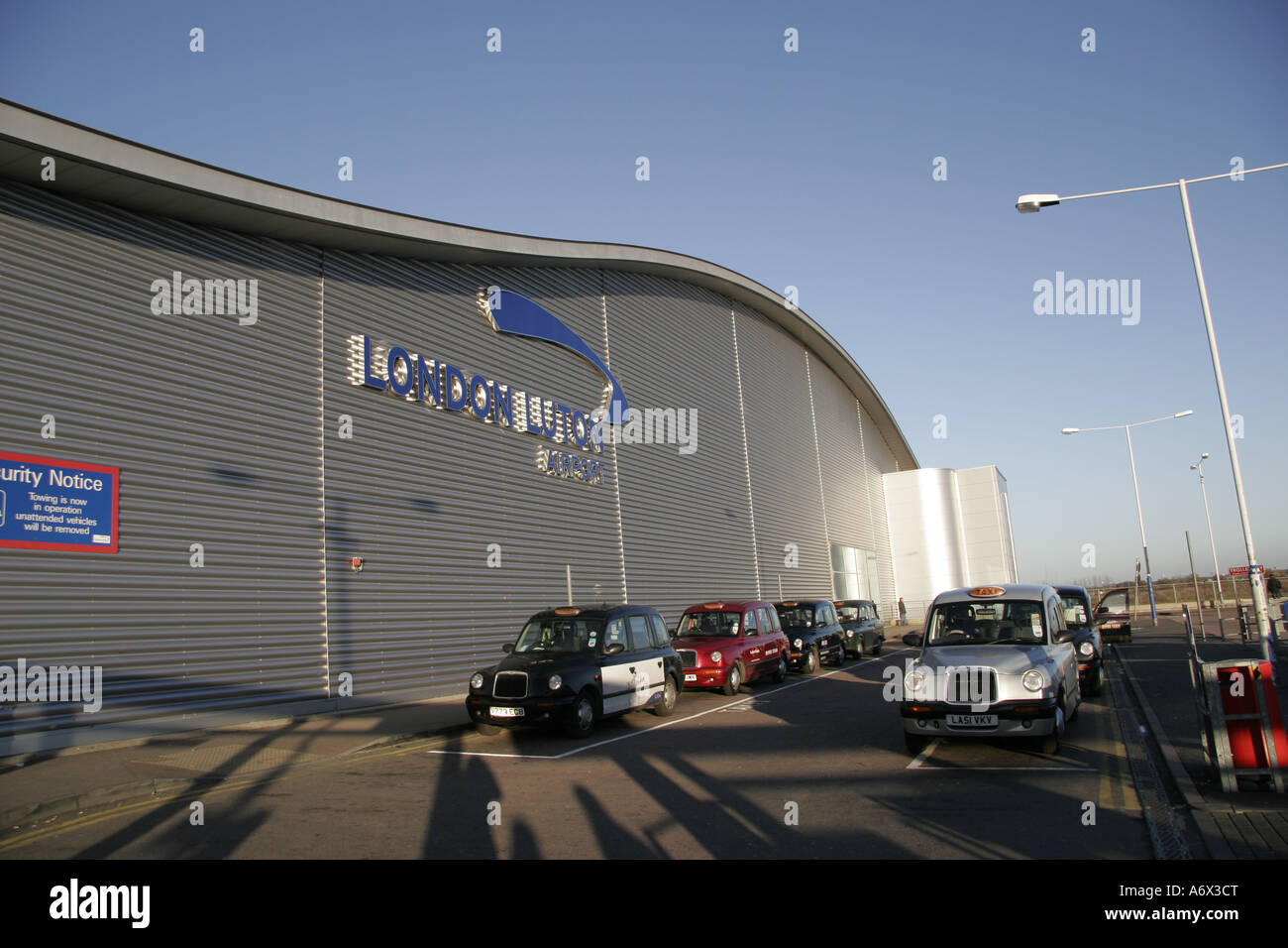 Cars parked in a row outside an airport London Luton Airport Luton