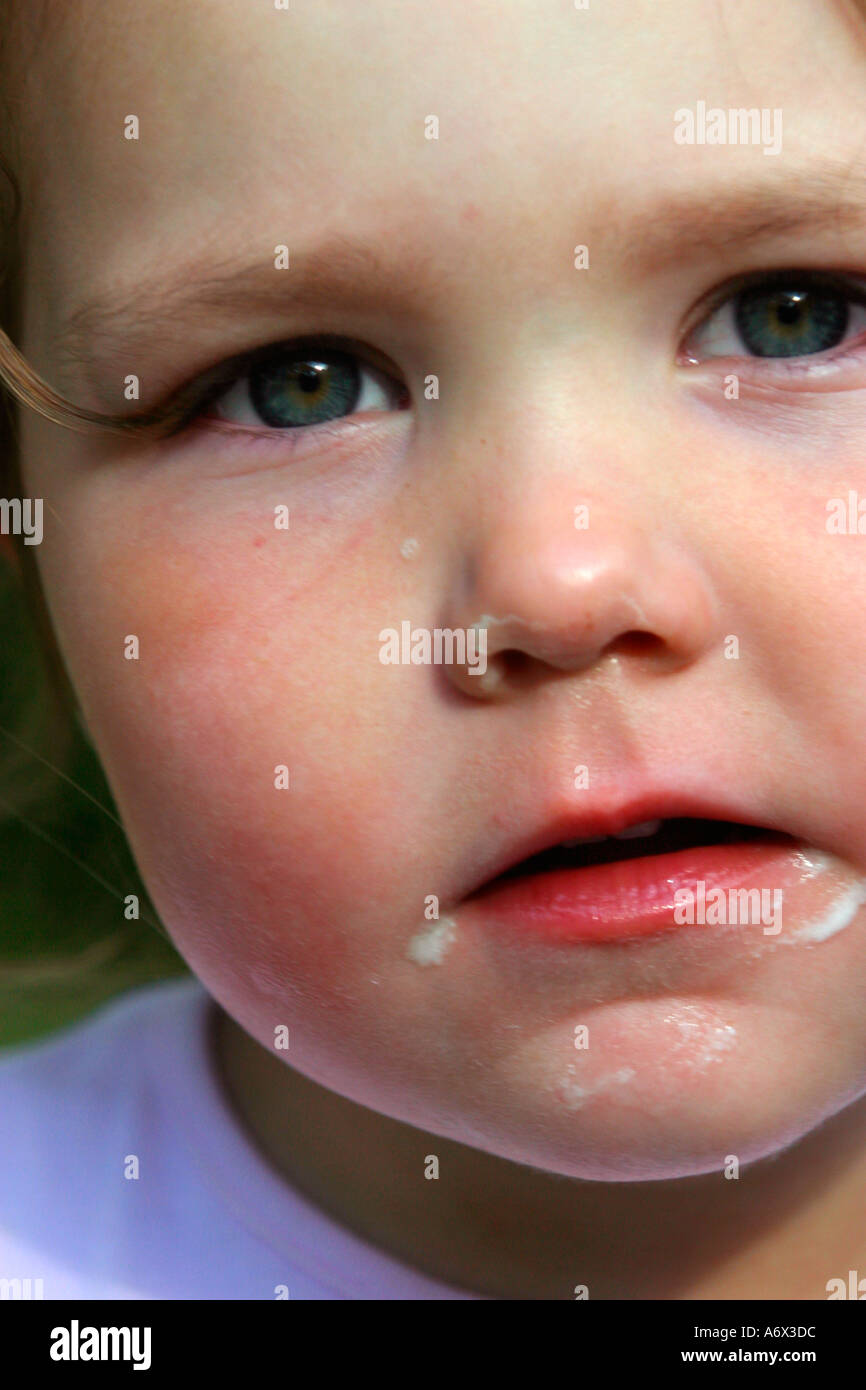 Young girl toddler after eating ice cream cone Stock Photo Alamy
