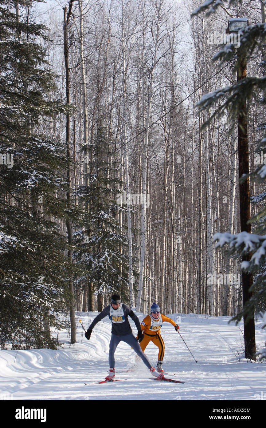 Two cross-country ski racers skate up a hill in the annual Sonot Kkaazoot ski race, Fairbanks, Alaska. Stock Photo