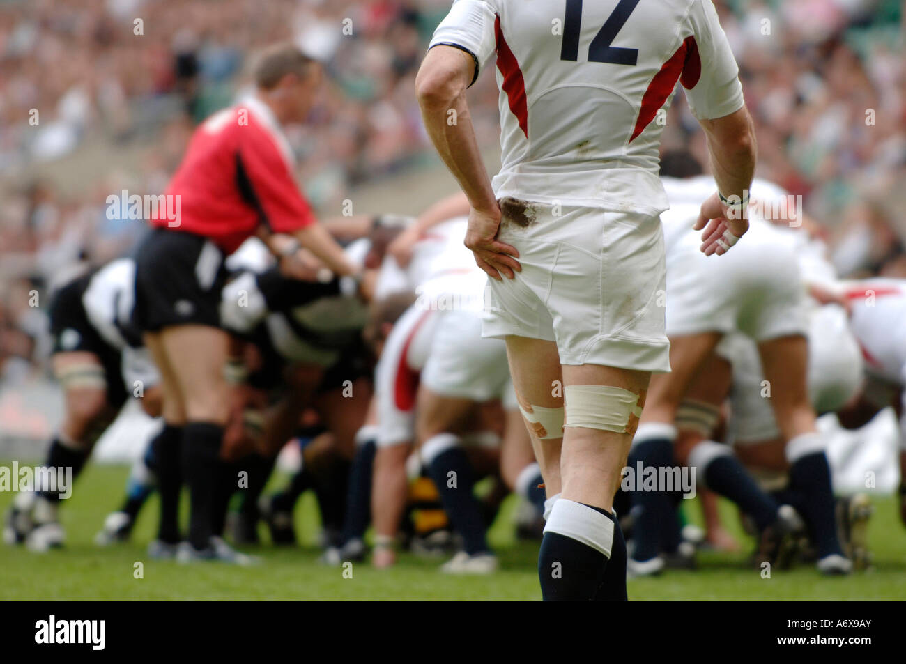An England rugby player wiping his hand whilst a scrum is being set Stock Photo