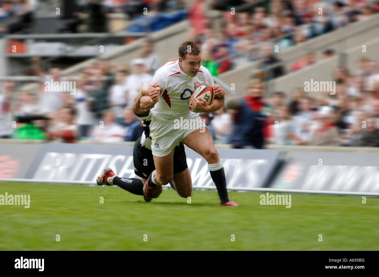 Olly Barkley about to be tackled whilst playing for England against the Barbarians at Twickenham in 2006 Stock Photo