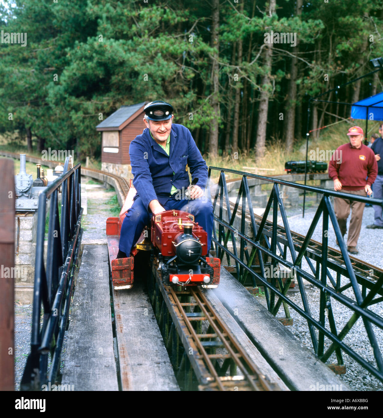 A train driver riding a miniature steam train Pembrey Country Park
